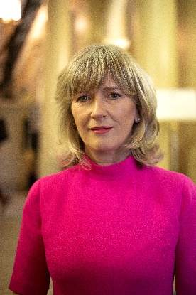A person in a pink shirt
Description automatically generated