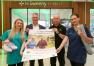 Four people outside Sweeny Pharmacy with yoga mat and trainers, to launch new campaign 