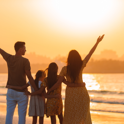 Image of a family on the beach in the sun