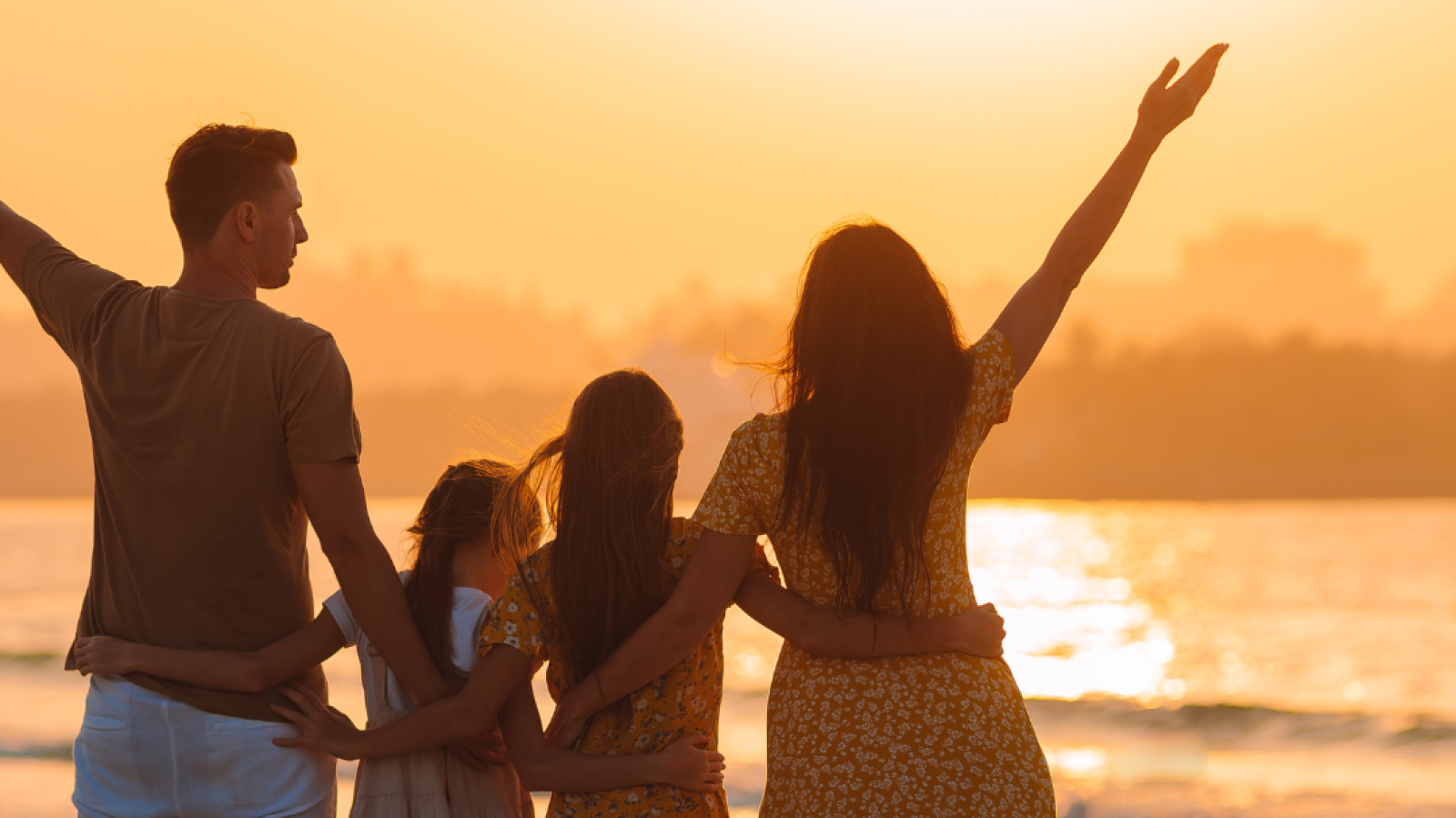 Image of a family on the beach in the sun