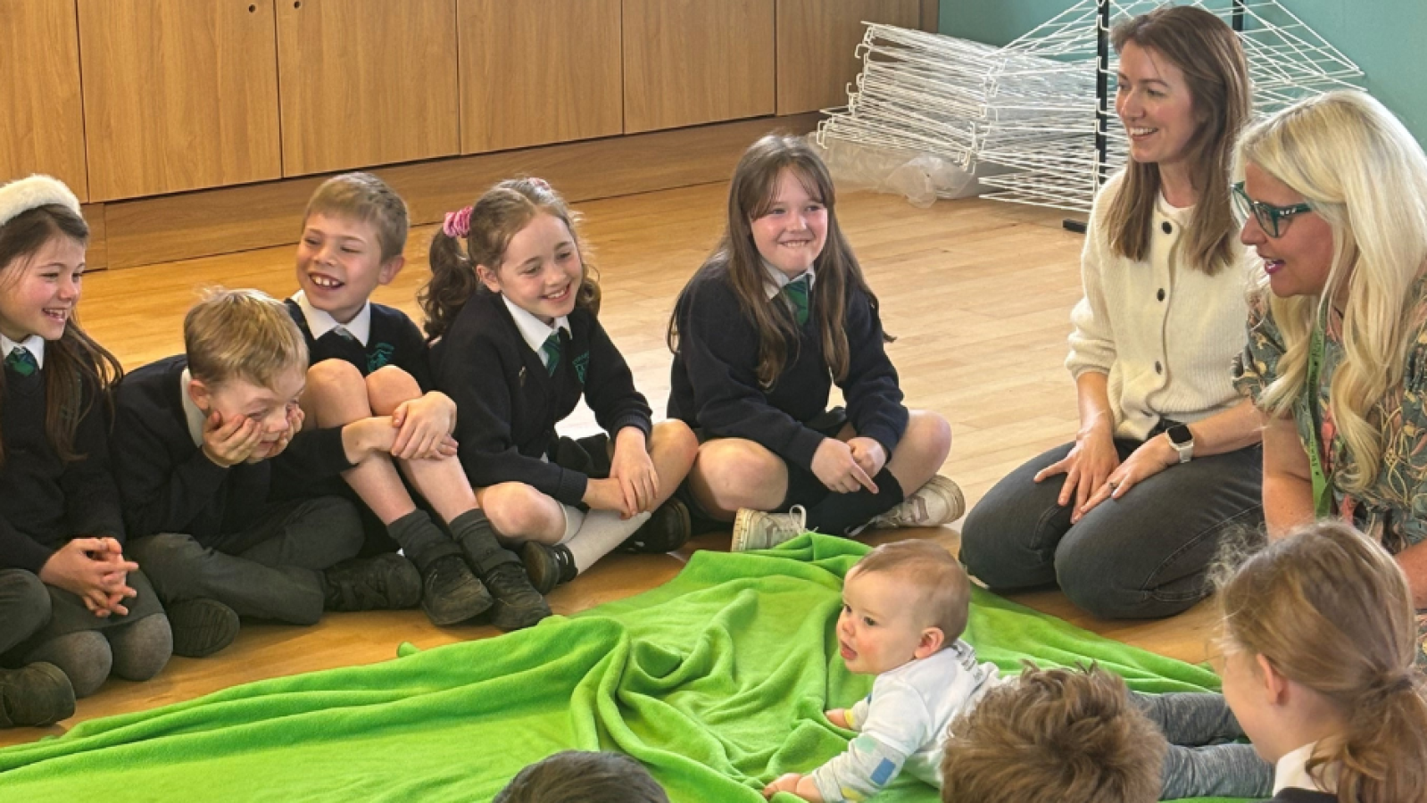 Photograph of primary 5 pupils with teacher and Roots of Empathy Mother/Baby during a lesson